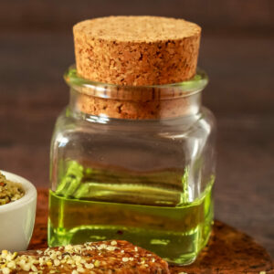 A white ceramic bowl full of shelled hemp, seeds and hemp oil A white ceramic bowl full of shelled hemp, seeds and hemp oil